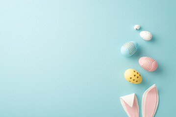 Easter concept. Top view photo of easter bunny ears and colorful eggs on isolated pastel blue background with copyspace - obrazy, fototapety, plakaty