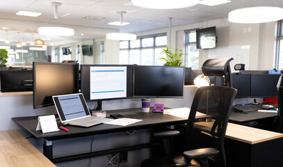 Empty open space office with desks, chairs and computers