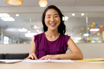 Image of asian woman having video call on laptop in office