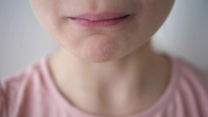 Close up of a young girls face eating