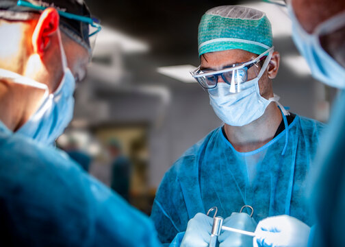 Surgeons holding surgiacl instruments during a simulation training lab