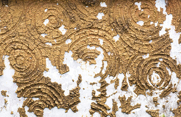 Concrete wall with broken swirl design texture