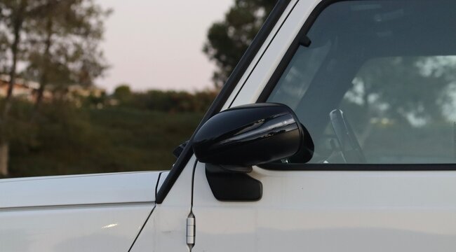 Brandless white offroading luxury vehicle. Generic SUV car, sleek pristine and newly cleaned paintwork. Newly washed new suv, glossy white and black, closeup image at sunset. Car wallpaper background.