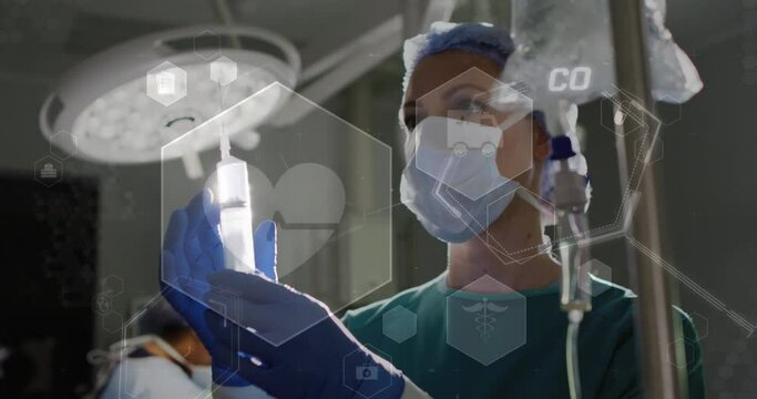 Animation of heart rate and medical icons over caucasian female surgeon preparing drip bag