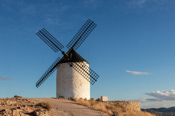 Fototapeta na wymiar Traditional windmill on a mountain at sunset of Consuegra, Toledo province, Castilla la Mancha, Spain