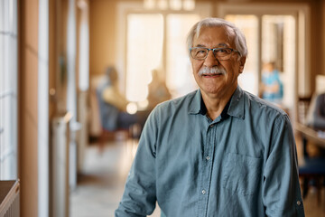 Portrait of happy senior man at retirement community looking at camera.