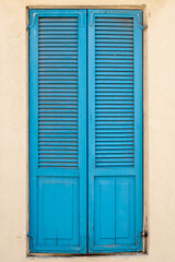 Vintage blue wooden shutters on a window