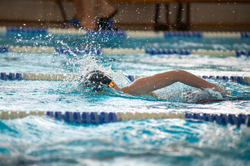 Swimmer swims freestyle swimming style in the pool