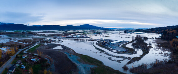 Aerial view of Fraser Valley farmers fields flooded from torrential rains, climate change effect, natural disaster, intense flooding, British Columbia.