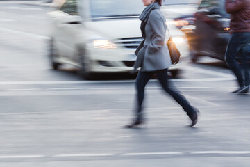 woman crossing a street in the city