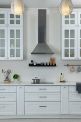 Fototapeta na wymiar Elegant kitchen interior with range hood and furniture