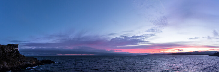 Cliffside ocean view with at sunset with waterfront property, Sooke, BC.