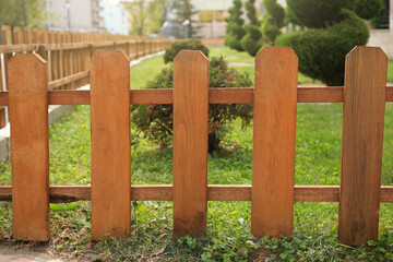 Small wooden fence on sunny day outdoors