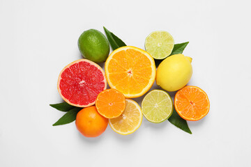 Different citrus fruits with fresh leaves on white background, top view