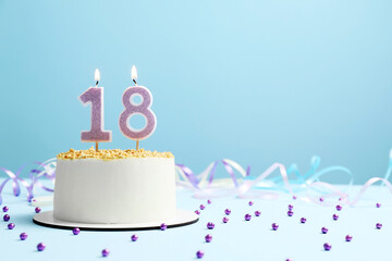 Coming of age party - 18th birthday. Delicious cake with number shaped candles on light blue background, space for text