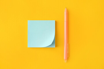 Blank paper note and pen on orange background, flat lay