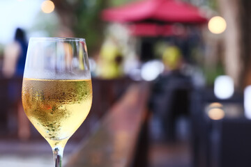 a glass of white wine in a restaurant, alcohol luxury background