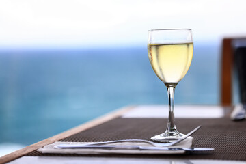 a glass of white wine in a restaurant, alcohol luxury background