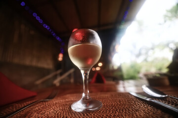a glass of white wine in a restaurant, alcohol luxury background