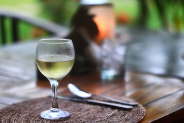 a glass of white wine in a restaurant, alcohol luxury background