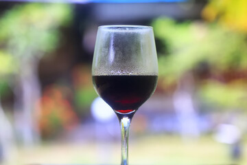 a glass of red wine in a luxurious background restaurant