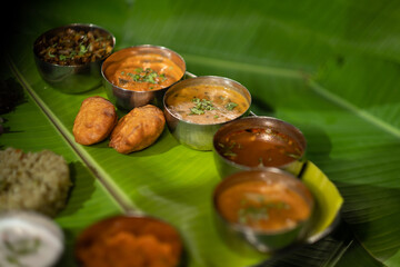 A meal plate ('bhojanam') with a variety of vegetarian dishes from the Andhra region of southern Indian, including fried potato dumplings ('aloo bajji') and spiced rice ('donne biryani').