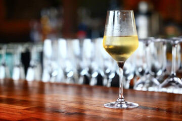 a glass of white wine in a restaurant, alcohol luxury background