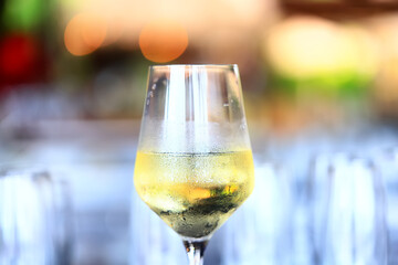 a glass of white wine in a restaurant, alcohol luxury background