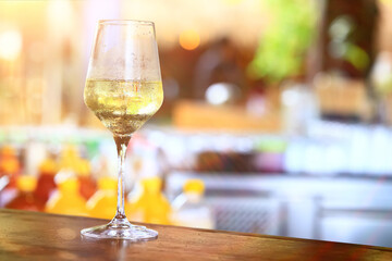 a glass of white wine in a restaurant, alcohol luxury background