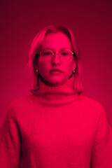 Portrait of a serious woman. Monochromatic picture. Viva magenta.