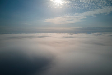 Aerial view from high altitude of earth covered with puffy rainy clouds forming before rainstorm
