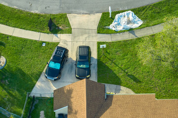 Aerial view of typical contemporary american private house with roof top covered with asphalt...