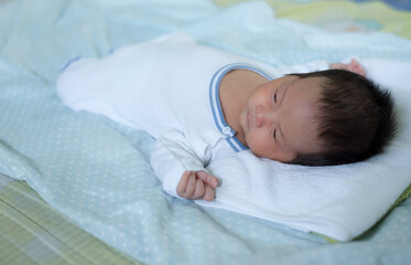 sleeping newborn baby boy asian