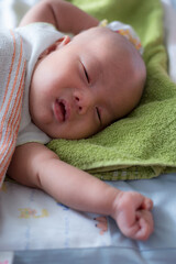 sleeping newborn baby boy asian