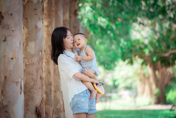 Asian Mather and baby in park