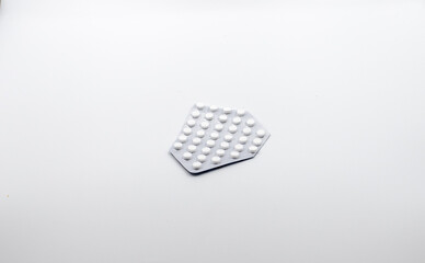 Cropped platinum with pills on a white background