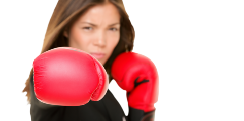 Boxing business woman punching towards camera wearing boxing gloves. Focus on boxing glove. Businesswoman isolated cutout PNG on transparent background.