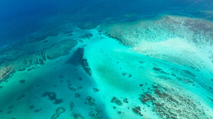 Sea water surface in lagoon with coral reef copy space for text. Top view transparent turquoise ocean water surface.