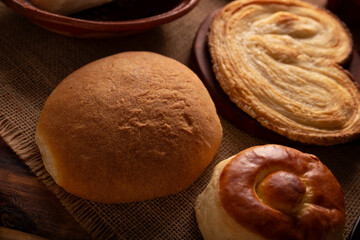 Hojaldra, bisquet and oreja. Hojldra is a typical bread in Mexico City, it is commonly cut in half and filled with chicken with mole or ham.