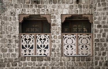 Old decorative windows. Traditional technique of an Arabic construction with coral stone.