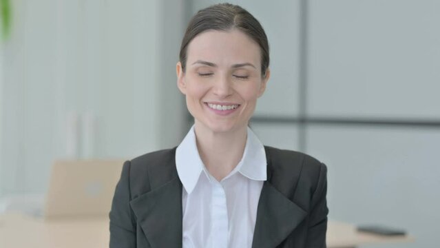 Portrait of Businesswoman Shaking Head in Approval