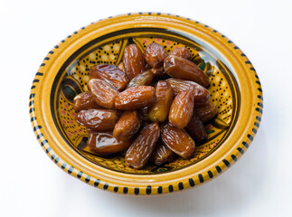 Close up of sweet and delicious Arabian dates served in a golden plate. Finest quality Saudi dates. 