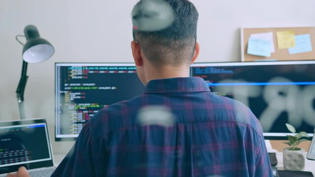 Young Asian man, developer programmer, software engineer, IT support, working on computer to check coding in bugging system