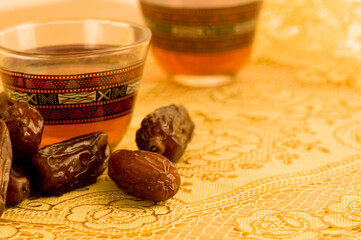 Black coffee with dates - a Middle eastern refreshment drink. Arabic dates and hot beverage.
