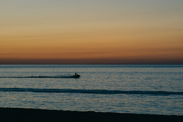 Sunset on the sea background, Yacht and tourists on the sea