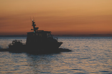 Sunset on the sea background, Yacht and tourists on the sea