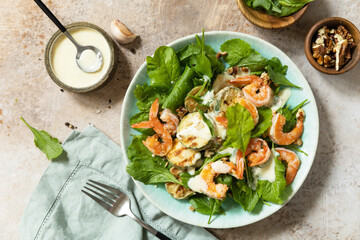 Healthy food concept. Vegetarian vegetable low carb lunch bowl. Diet salad shrimps with arugula, grilled zucchini and walnut. View from above.