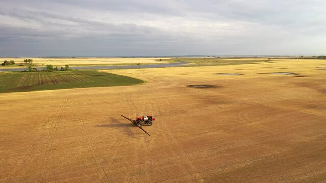 Aerial view of farmland in North Dakota, USA. American countryside, farming vehicles in the field