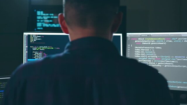 Young Asian man, developer programmer, software engineer, IT support, working hard at night overtime on computer to check coding in bugging system