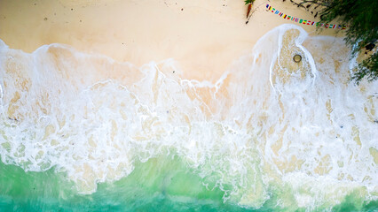 Aerial view of the waves splashing to the beach.